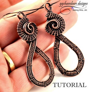 May include: A pair of copper wire earrings with a spiral design and a teardrop shape. The earrings are handmade and have a rustic, organic look. The earrings are shown in a close-up photo, with the text "TUTORIAL" visible in the lower right corner.