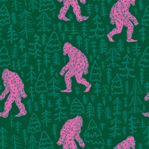 May include: A repeating pattern on a dark green background featuring bright pink illustrations of Bigfoot creatures walking among stylised evergreen trees. The design consists of multiple figures of the hairy creature interspersed with various pine tree outlines.