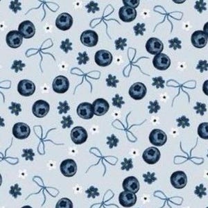 May include: A pale blue fabric featuring a repeating pattern of dark blue blueberries, delicate blue bows, and small white flowers. The blueberries are paired in twos. The flowers have white petals and yellow centers.
