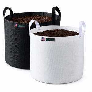 May include: Two cylindrical fabric grow bags, one black with black handles and one white with white handles, both filled with dark soil. Each bag features a small rectangular label with a U.S. flag icon and the text Rain Science.