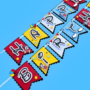May include: A colorful Happy Birthday banner with Mickey Mouse characters and red, yellow, blue, and white colors. The banner reads "Happy Birthday".