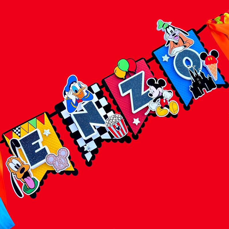 May include: A colorful Disney-themed banner with the name "ENZO" spelled out in black letters. The banner features Mickey Mouse, Donald Duck, Goofy, and other Disney characters.