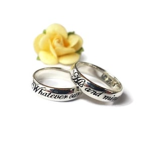 May include: Two silver rings with the inscription "Whatever our" on one ring and "His and mine" on the other ring.