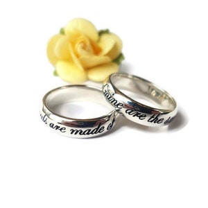 May include: Two silver rings with the words "Girls are made of" and "dreams are the dust" engraved on them.