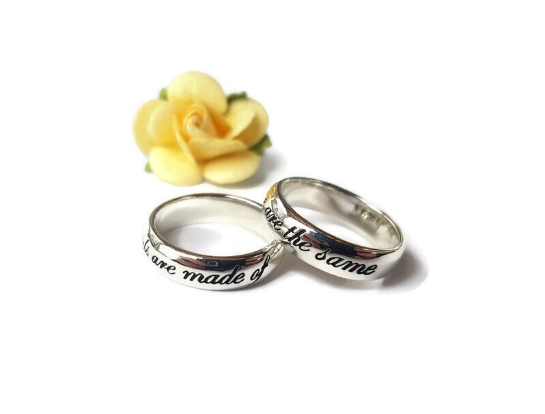 May include: Two silver rings with the inscription "We are made of the same" and "We are the same" on them.