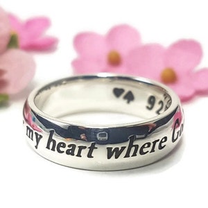 May include: A silver ring with the inscription "You are my heart where God"