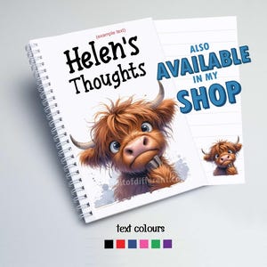 May include: A white spiral notebook with a cartoon Highland cow illustration. The notebook has the text "Helen's Thoughts" in black. The text "ALSO AVAILABLE IN MY SHOP" is in blue on a white background.