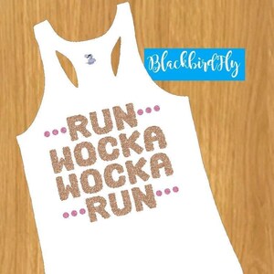 May include: White tank top with a gold glitter design that says "...RUN...WOCKA WOCKA...RUN..."