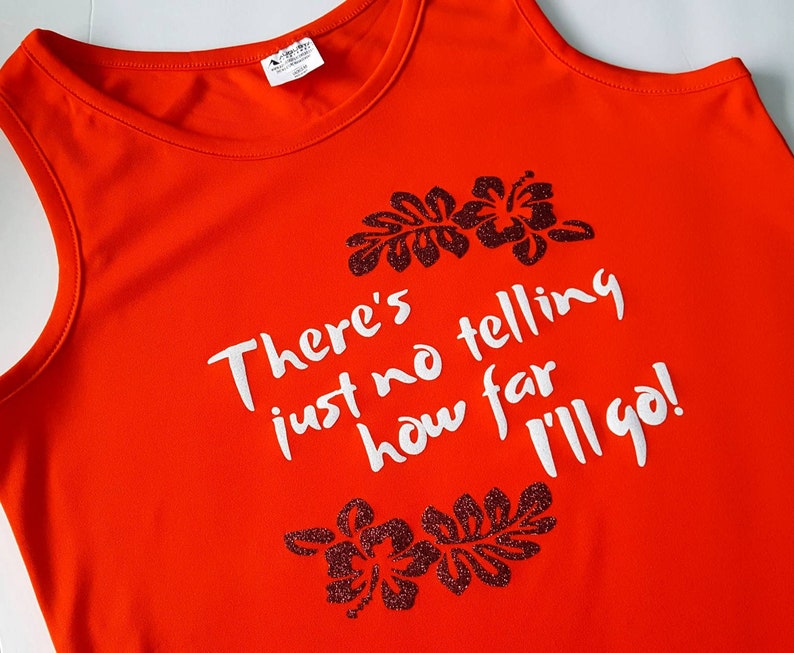 May include: Orange tank top with a white graphic that says "There's just no telling how far I'll go!" with black glitter hibiscus flowers on either side of the text.