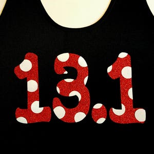 May include: Red tank top with white polka dots and the number 13.1 printed in red.