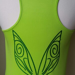 May include: A lime green tank top with a green glitter fairy wing design on the back.