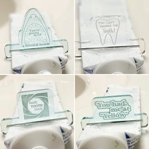 May include: Four different designs for a toothpaste tube squeezer. The designs are printed on clear plastic and feature a shark, a tooth, a swirl, and the text "You had me at Yellow".