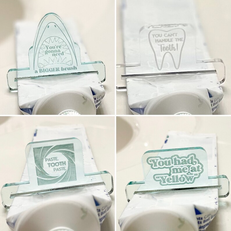 May include: Four different designs for a toothpaste tube squeezer. The designs are printed on clear plastic and feature a shark, a tooth, a swirl, and the text "You had me at Yellow".