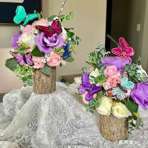 2  Butterfly Boquet centerpieces on tree stump