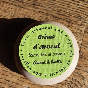 May include: A green and white round soap bar label with the text "Savon artisanal S.A.F. Creme d'avocat Savon doux et cremeux Vegetal Hydrate et adoucit Avocat & karite 100."