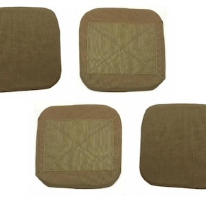 May include: Five tan-colored, square-shaped patches. Four patches have a rectangular, textured fabric section stitched onto the center, forming an X pattern. The fifth patch is solid tan. All patches have rounded corners.