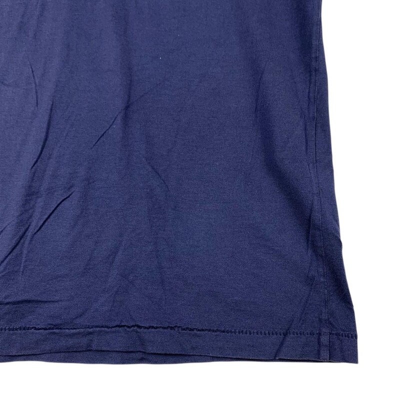 May include: A solid navy blue t-shirt featuring a standard crew neckline and short sleeves. The fabric has a smooth texture with visible stitching along the bottom hemline, showcasing a classic construction and a deep, uniform colour throughout.