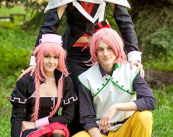 May include: Three people dressed in cosplay costumes. The person in the center is wearing a black and white costume with a pink wig. The person on the left is wearing a black and red costume with a pink wig. The person on the right is wearing a white and green costume with a pink wig.