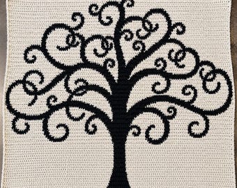 May include: A square crochet blanket featuring a high-contrast design of a black tree with intricate, swirling branches set against a solid cream-colored background. The tree pattern is created using a dense stitch technique with clear, defined edges.