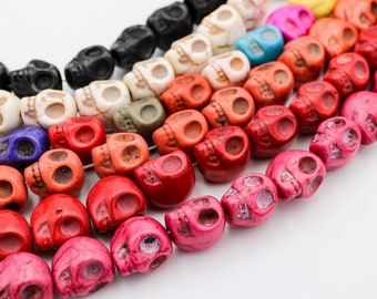 May include: A strand of colorful skull-shaped beads. The beads are made of a smooth, polished stone and come in a variety of colors, including red, pink, orange, blue, green, and black.