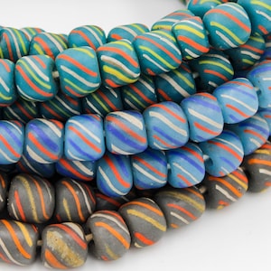 May include: A close-up of a strand of colorful glass beads. The beads are made of opaque glass and have a swirling pattern of blue, green, orange, and white. The beads are strung on a clear thread.