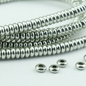 130 Silver Spacer Metal Beads. 7mm Silver Plated Donut Beads. SKU-MB-142-S