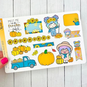 May include: A sheet of planner stickers with a harvest theme. The stickers feature pumpkins, sunflowers, and cartoon characters. Text on the stickers includes "Meet Me at the Pumpkin Patch". A blue truck carries pumpkins. The color palette includes orange, yellow, and blue.