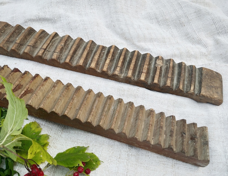 Puede incluir: Dos lavaderos de ropa de madera antiguos con una superficie texturizada. Los lavaderos son de madera marr&oacute;n claro con ranuras marr&oacute;n oscuro. Los lavaderos est&aacute;n sobre una superficie de tela blanca.