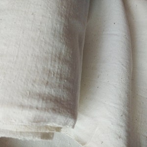 May include: Two pieces of white fabric folded together. The fabric has a slightly textured surface.