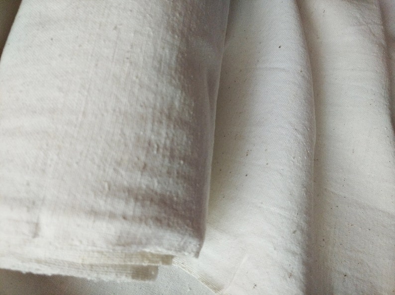 May include: Two pieces of white fabric folded together. The fabric has a slightly textured surface.