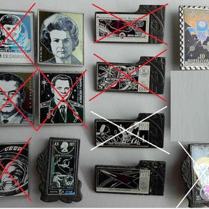 May include: A collection of rectangular metal pins featuring portraits of Soviet cosmonauts, space exploration imagery, and vintage postage stamp designs with Cyrillic text, including a vertical pin depicting a space probe labeled 10 POCHTA SSSR 1982.