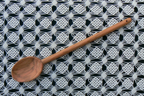 Carved from a single piece of centuries-old olive wood, each spoon is a one-off with natural grain patterns you literally cannot replicate — 1,066 people have hearted it for a reason.