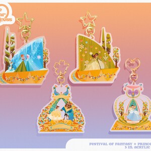 May include: Four 3-inch acrylic charms featuring Disney princesses. The charms are shaped like the floats from the Festival of Fantasy parade. The charms include Elsa and Anna from Frozen, Tiana and Prince Naveen from The Princess and the Frog, Belle and the Beast from Beauty and the Beast, and Cinderella and Prince Charming from Cinderella. Each charm has a gold-colored key ring.