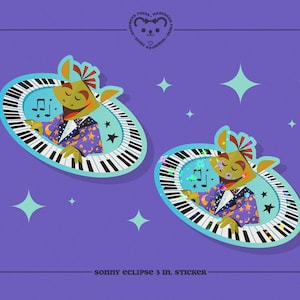 May include: Two 3-inch stickers featuring a green, cartoon character playing a keyboard. The character is wearing a purple jacket with stars and a white shirt. The keyboard is surrounded by a blue circle with stars and glitter.