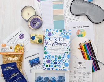 May include: A self-care package for grief and loss with a blue and white book titled "Grief for Atheists" by Betsy DeVille, a blue and white quilling kit, a daily planner, a sleep mask, a candle, a box of chicken noodle soup mix, a box of hot cocoa mix, a daily feelings gradient worksheet, a grief bingo for atheists game, and colored pencils.