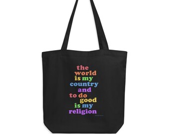 May include: Black tote bag with the text "the world is my country and to do good is my religion" in rainbow colors.