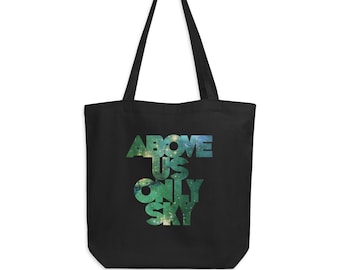 May include: Black tote bag with a galaxy print design and the text "ABOVE US ONLY SKY" in white.