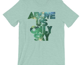 May include: A light blue t-shirt with the words "ABOVE US ONLY SKY" printed in a green and black galaxy pattern.