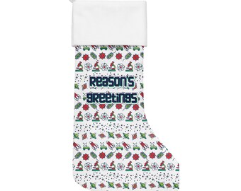 May include: A white Christmas stocking with a white cuff and a loop for hanging. The body of the stocking is patterned with science-themed graphics in red, green, and blue, and the text "Reason's Greetings".