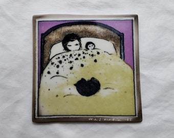 May include: A ceramic tile with a hand-painted illustration of two figures in a bed with a purple background. The tile is framed in brown and has the text "w.d.s. austin -85" in the bottom right corner.