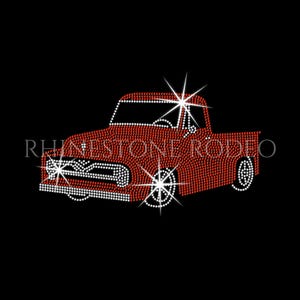 May include: Red rhinestone pickup truck design with white accents on a black background. The truck features sparkling wheels and headlights. The text "RHINESTONE RODEO" is displayed in white.