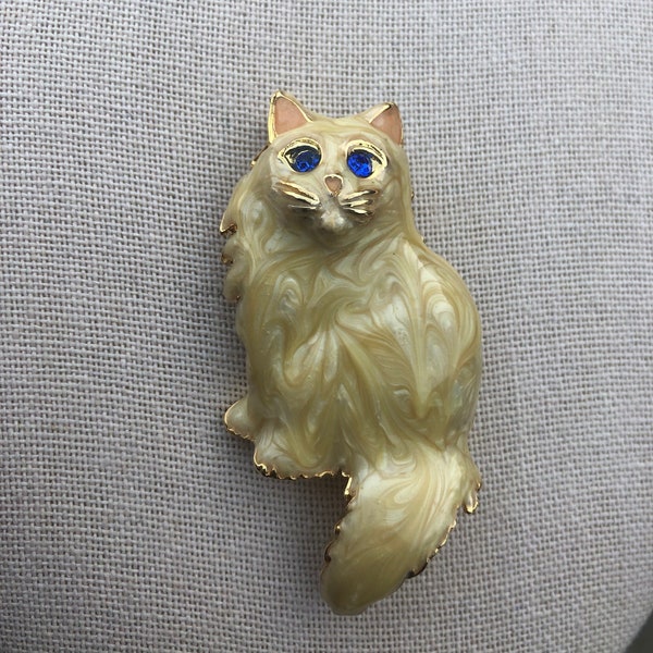 Vintage cream color enamel cat brooch with gold tone accents and blue rhinestone eyes