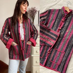 Peut inclure: Une veste matelassée à rayures avec un col mandarin et des boutons en bois. La veste est faite d'un tissu doux et léger et a une coupe décontractée.