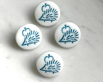 May include: Four round white buttons, each featuring a blue embossed graphic of a hedgehog positioned beneath an apple. The buttons have a smooth, glossy finish and a consistent circular shape, displaying a clear, detailed illustration on the surface.