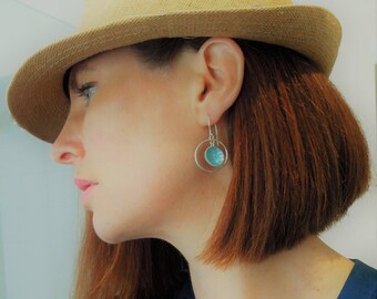 Sterling silver, light blue enameled earrings with suspended circle in hoop, hook on pieced earrings.