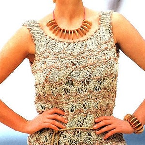 May include: A beige and brown crocheted sleeveless top with a wooden bead necklace. The top has a loose fit and a scoop neck.