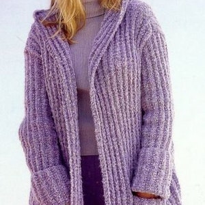 May include: A long, purple cardigan with a hood and pockets. The cardigan is knitted with a ribbed texture.