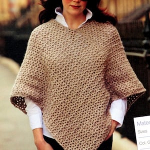 May include: A brown crocheted poncho with a diamond pattern. The poncho has a wide neckline and a loose fit.