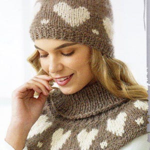 May include: A knitted hat and cowl set in brown with white heart patterns. The hat is a beanie style, and the cowl is a neck warmer. The set is made of a soft, textured yarn, perfect for cold weather.