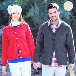 May include: A couple in knitwear. The woman is wearing a red cardigan, white trousers, and a white hat. The man wears a grey cardigan over a plaid shirt and beige trousers. The image includes the text "Easy Knit".